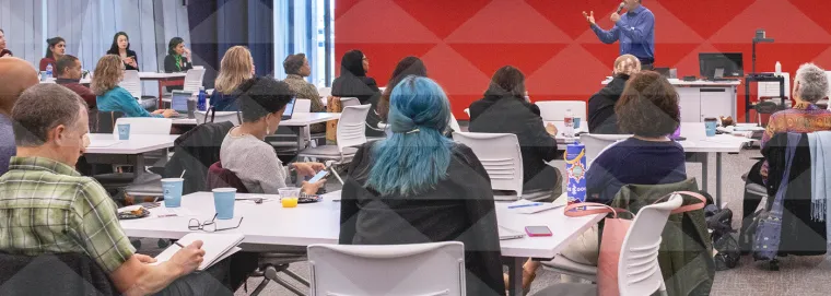 Faculty listening to a presentation inside a collaborative classroom.