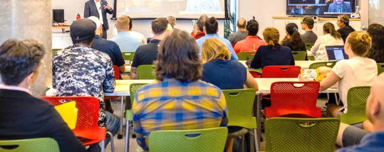 Attendees listening to a presentation during a CUES event in ENR2, Room N595.